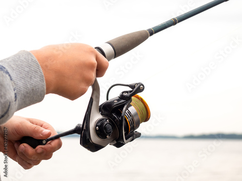 Spinning in the hand. The concept of fishing, outdoor recreation, hobbies.
