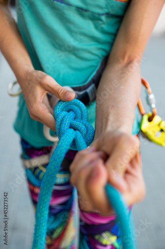 rock climber tying a safety knot