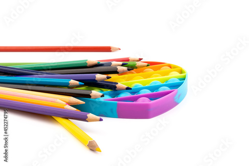 School supplies, children toy popit anti-stress on white background. Concept of the back to school.