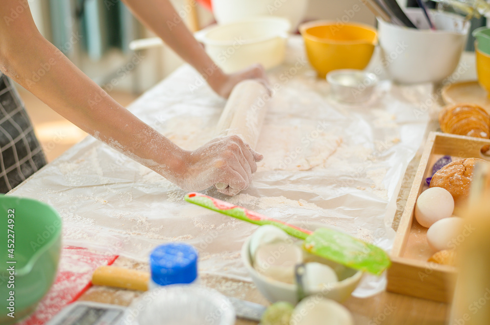 A young beautiful Asian woman is baking in her kitchen , bakery and coffee shop business A young beautiful Asian woman is baking in her kitchen , bakery and coffee shop business