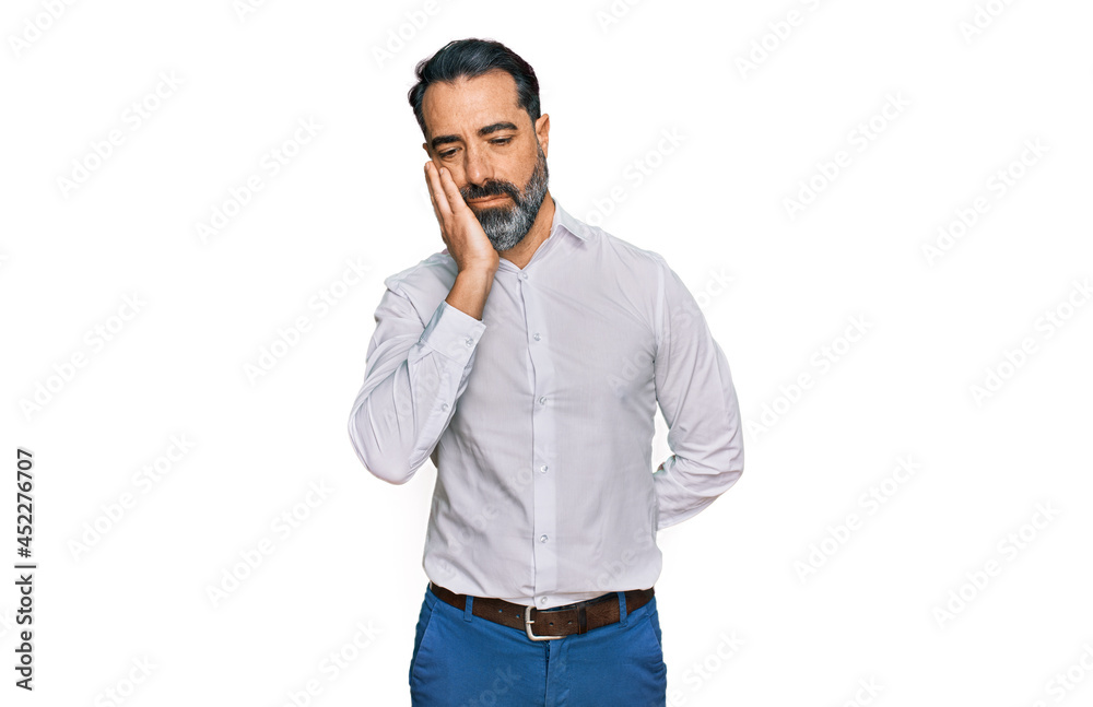 Middle aged man with beard wearing casual white shirt thinking looking tired and bored with depression problems with crossed arms. Middle aged man with beard wearing casual white shirt thinking looking tired and bored with depression problems with crossed arms.