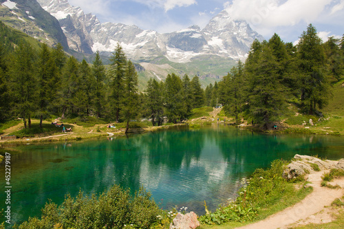 View of idyllic emerald alpine lake with matterhorn massif in the background in Valle d'Aosta, Italy