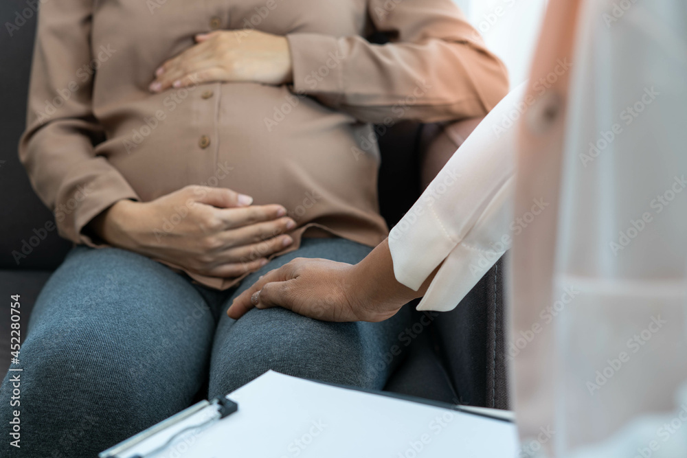 A doctor, psychiatrist, or obstetrician discusses symptoms of gestational depression in pregnant women while encouraging to become pregnant. The mother is unhappy, worried and stressed. Mental health.