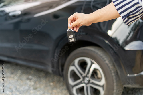 An employee of a tourist car rental company presents the car keys with a test drive. Good service before agreeing to a lease or purchase contract. © Shisu_ka