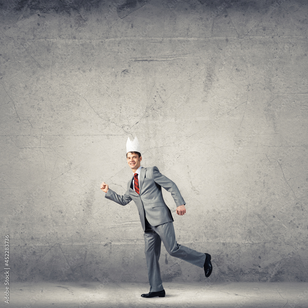 King businessman in elegant suit running in empty room King businessman in elegant suit running in empty room