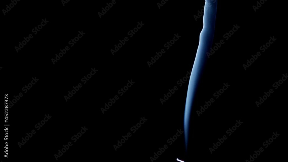 Incense stick are burning and smoke on black background, Smoke from incense. Slow motion. Real Smoke on black. Ideal for background or over-layer with blending mode add, screen, lighten. Incense stick are burning and smoke on black background, Smoke from incense. Slow motion. Real Smoke on black. Ideal for background or over-layer with blending mode add, screen, lighten.