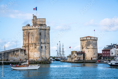 The Chain and Saint Nicolas towers of La Rochelle during summer with blue sky marking the entryway of the old port La Rochelle France