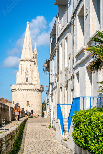 Fototapeta Naklejka Na Ścianę i Meble -  Vertical view of the Lantern Tower and Sur-Les-Murs medieval street in La Rochelle France