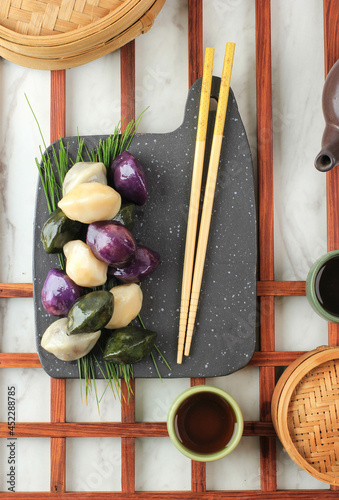 Top View Songpyeon Traditional Chuseok Day Food, Korean Half Moon Shaped Rice Cake. Made from Korean Rice Flour with Sesame Seed or Chopped Nuts, Honey, or Red Bean Paste photo