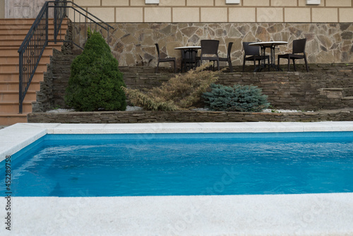 Pool with blue water. Swimming pool in the courtyard of the hotel. Landscaping