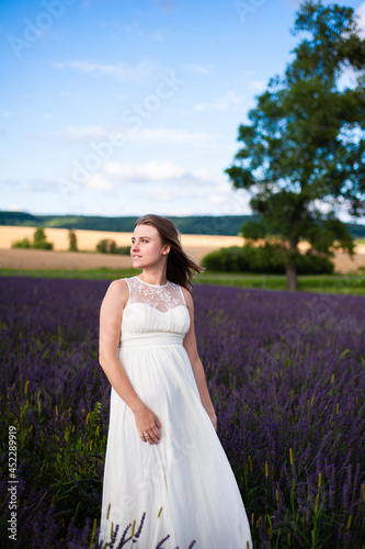 Beautiful smiling pregnant woman on the field