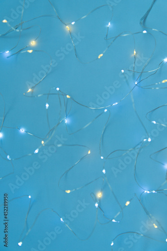 Texture of New Year or Christmas garland on a blue background. Abstract painting