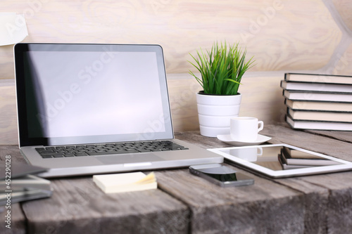 PC laptop, tablet and phone on wooden table