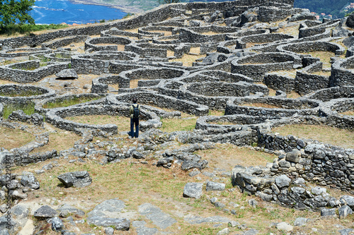 Carta da parati a visitor walks through the Celtic fort of Mount Santa Trega with the Atlantic O