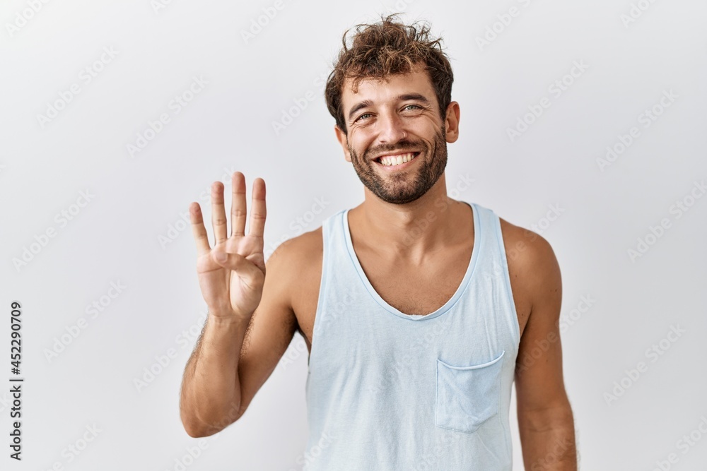 Young handsome man standing over isolated background showing and pointing up with fingers number four while smiling confident and happy. Young handsome man standing over isolated background showing and pointing up with fingers number four while smiling confident and happy.