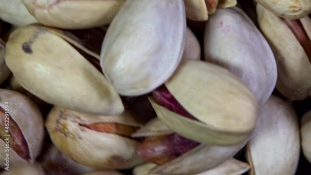macro footage rotating and stirring pistachio nuts