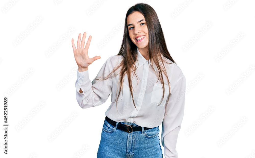 Young brunette teenager wearing business white shirt showing and pointing up with fingers number five while smiling confident and happy. Young brunette teenager wearing business white shirt showing and pointing up with fingers number five while smiling confident and happy.