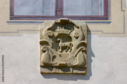 Stone relief coat of arms on the wall of 16th century renaissance Sucha Beskidzka castle, Sucha Beskidzka, Poland photo
