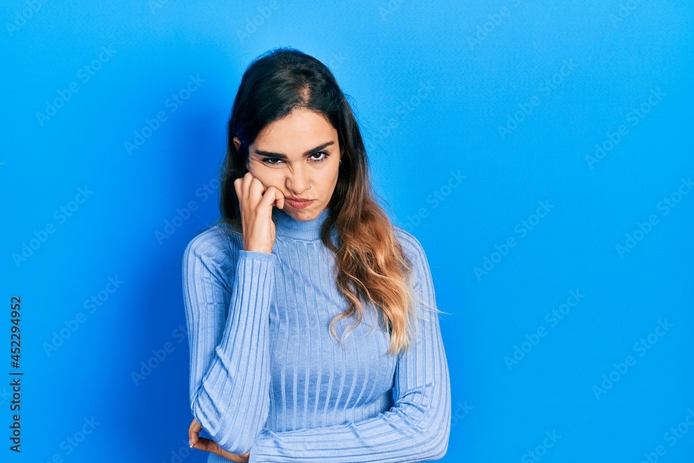 Young hispanic girl wearing casual clothes thinking looking tired and bored with depression problems with crossed arms. Young hispanic girl wearing casual clothes thinking looking tired and bored with depression problems with crossed arms.