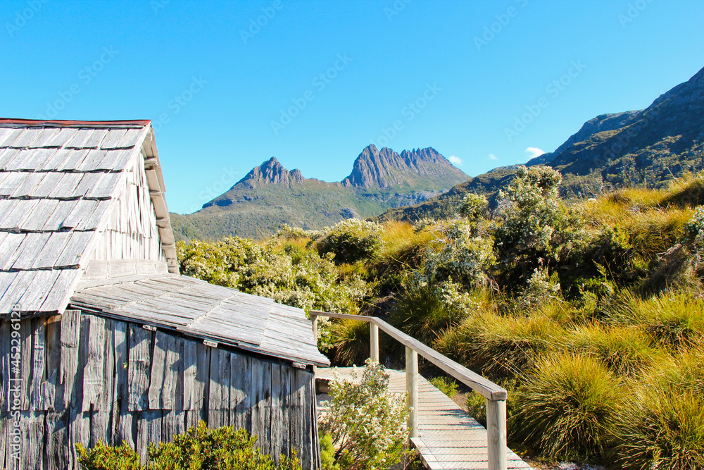 Fototapeta premium Wooden cabin in foreground of Cradle Mountain Dove Lake Tasmania Australia. No people, space for copy.