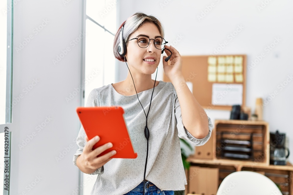 Young caucasian call center agent working at the office. Young caucasian call center agent working at the office.