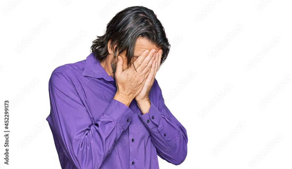 Middle age handsome man wearing business shirt with sad expression covering face with hands while crying. depression concept. Middle age handsome man wearing business shirt with sad expression covering face with hands while crying. depression concept.