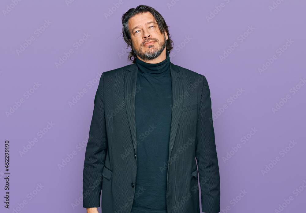 Middle age handsome man wearing business clothes relaxed with serious expression on face. simple and natural looking at the camera. Middle age handsome man wearing business clothes relaxed with serious expression on face. simple and natural looking at the camera.