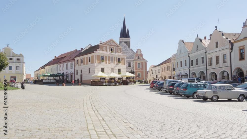 A quaint city square with colorful buildings on a sunny day A quaint city square with colorful buildings on a sunny day