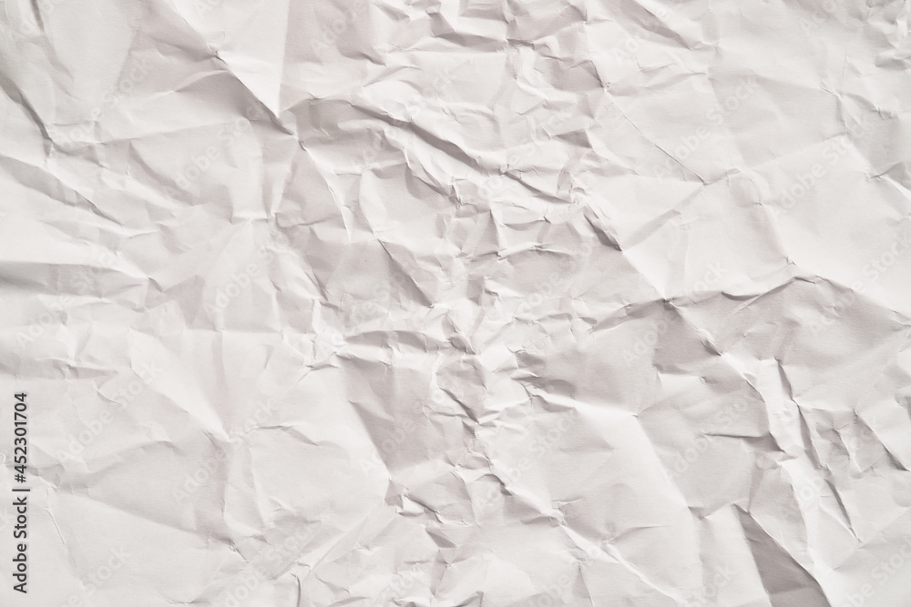 Foto de White crumpled paper texture with wrinkles. Damaged and torn sheet  do Stock | Adobe Stock