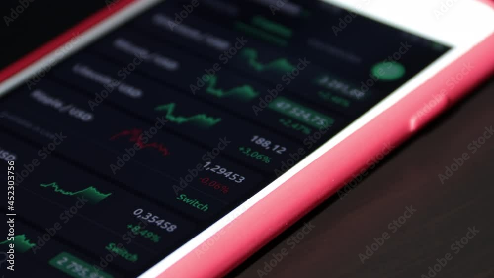 Trading and invest. Growth and decline data with updating stats at mobile screen Trading and invest. Growth and decline data with updating stats at mobile screen