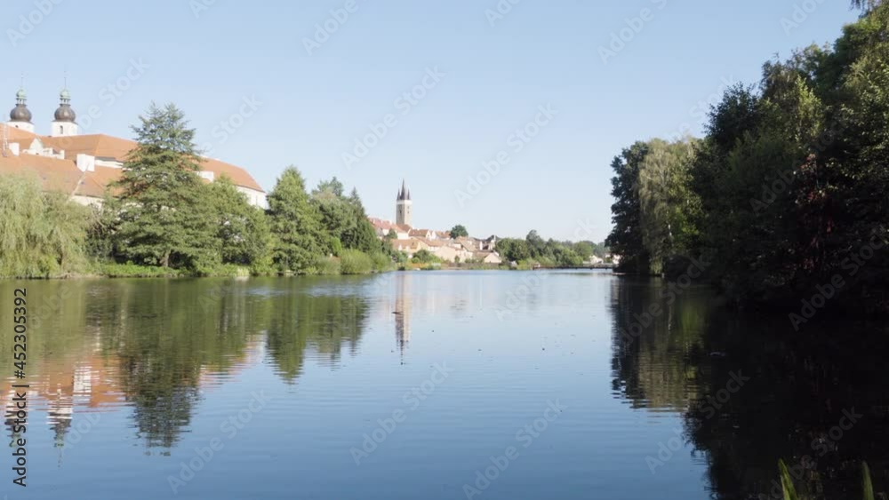 Buildings in a cityscape across a river in the foreground Buildings in a cityscape across a river in the foreground