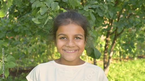 Portrait pakistani or indian Girl Looking at Camera. Young Laughs Happily Child Looking at Camera. Closeup. Inquisitive Kid Girl Portrait. Face Funny Contemplative Kid Child.