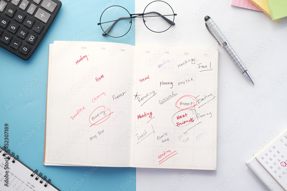high angle view of weekly planner on table. high angle view of weekly planner on table.