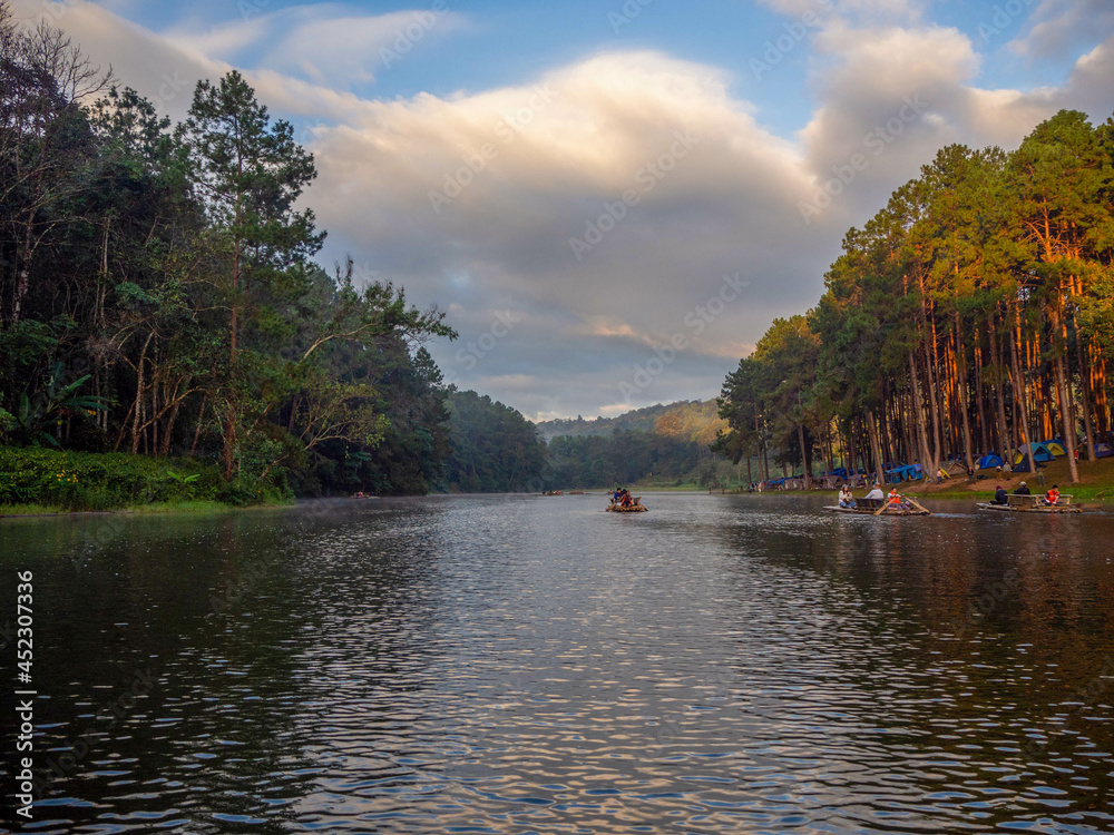 The beautiful sunshine with the pine and the raft on the reservoir of the higher mountain, Pang Oung, which dubbed is as Switzerland, Mae hong son, Thailand.