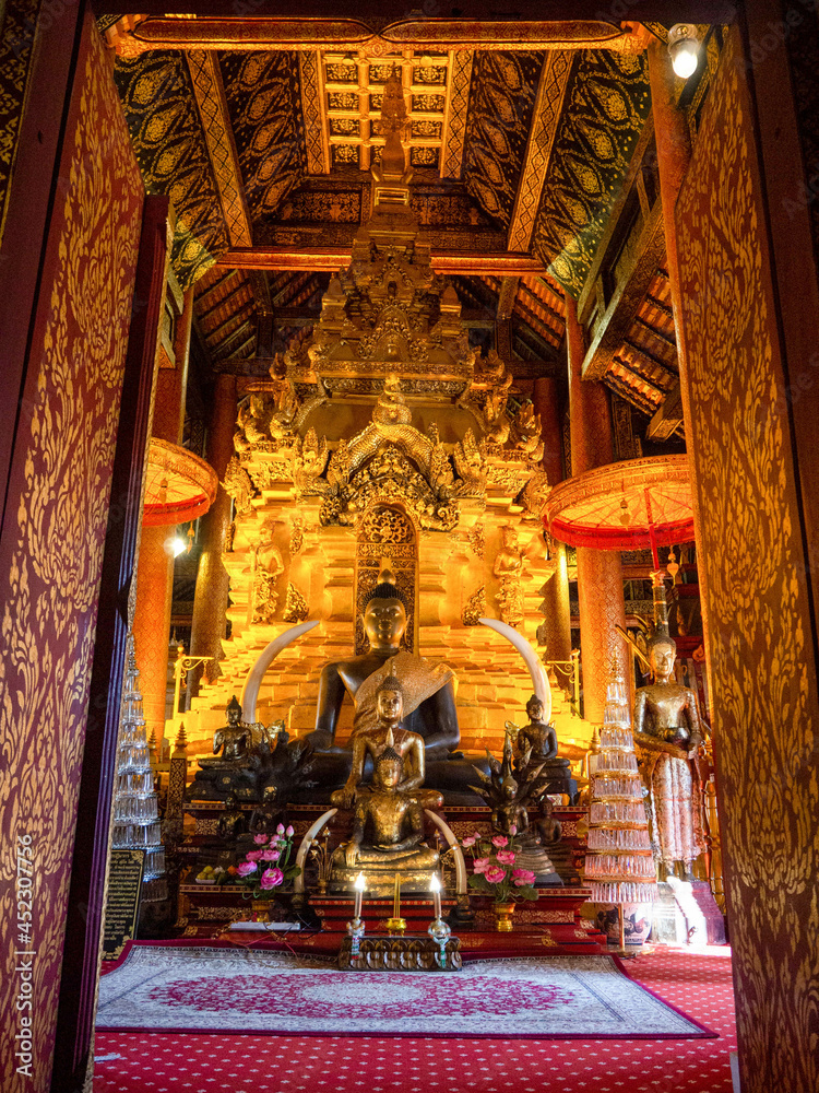 The gold Buddha In the sanctuary at Wat Phra Dhatu Sri Chom Thong Temple, the temple of Year of the Rat in Chiang Mai, Thailand.