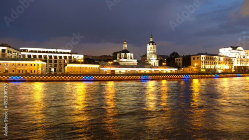 Night city view of architecture, churches and the Moskva river in Moscow, Russia. Reflection of lights in the water. © Yuliya