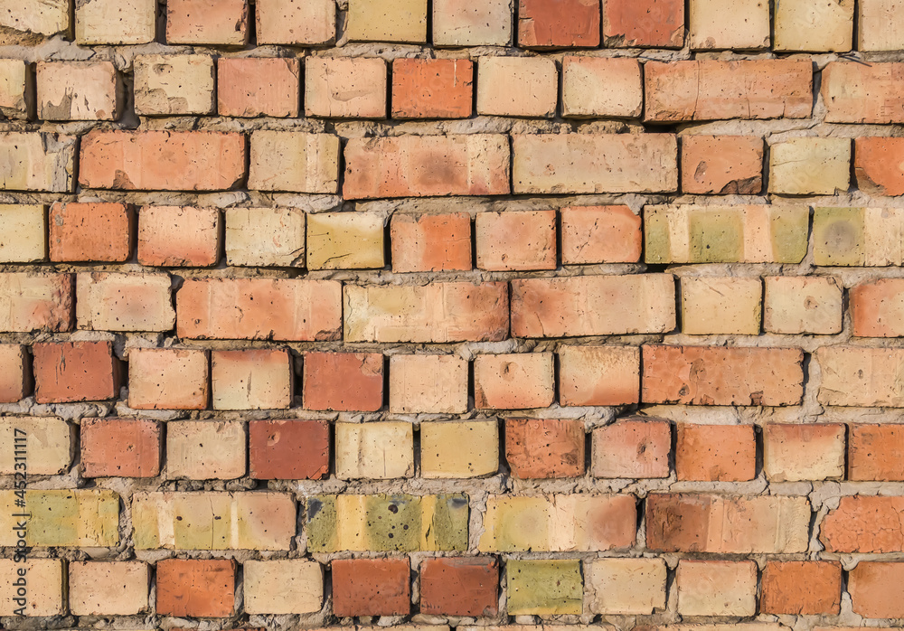 Fototapeta premium Brickwork during the construction of a residential building as a background.