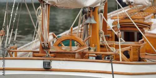 Foto Expensive retro sailing boat (ketch) moored to a pier in a new yacht marina