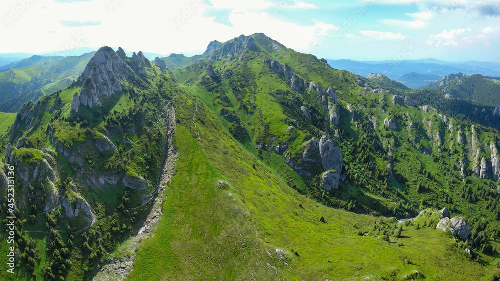 Aerial panorama of Ciucas Mountains crests. On the alpine grasslands, eroded calcareous boulders are forming interesting stone conglomerations. Carpathians, Romania.