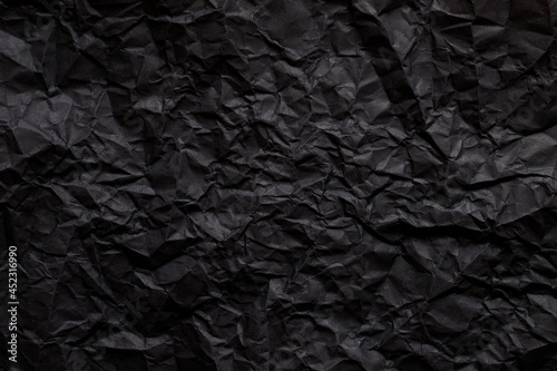 Black abstract background texture by dark wrinkled paper