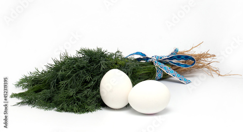 green dill lies on the table next to boiled eggs.