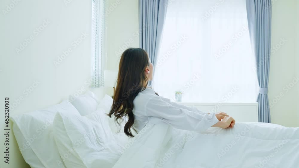 Asian beautiful girl in pajamas wake up in the morning with happiness. Asian beautiful girl in pajamas wake up in the morning with happiness.