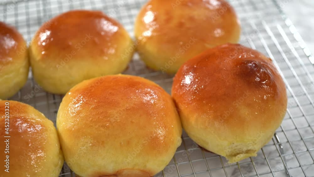 Step by step. Cooling freshly baked brioche buns on a kitchen cooling rack. Step by step. Cooling freshly baked brioche buns on a kitchen cooling rack.