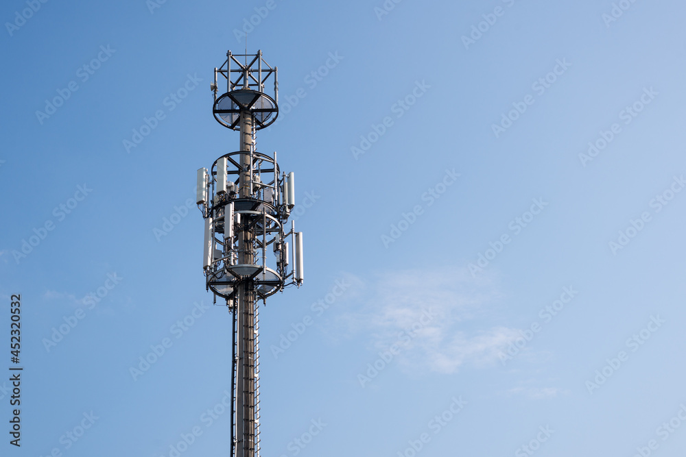Telecommunication mast against blue sky