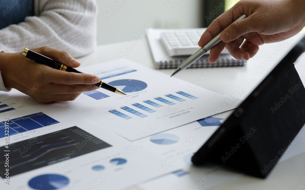 Fototapeta premium Close up of hand business woman working data document graph chart report marketing research development planning management strategy analysis financial and accounting concept.