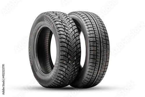 winter tires wheels are new isolate. friction velcro wheel and studded tire next to two pieces © Vladimir Razgulyaev