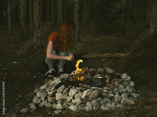 woman outdoors near campfire tourism forest travel