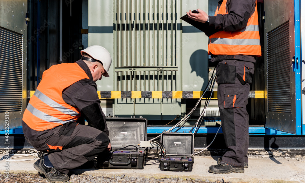Fototapeta premium Execution of electrical measuring works on the power transformer