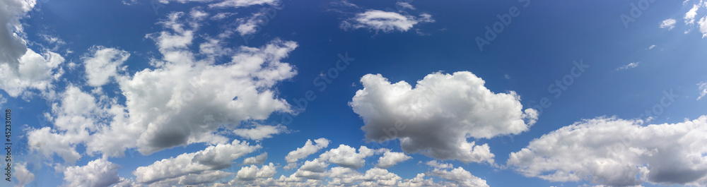Fototapeta premium white fluffy clouds on a background of blue sky. Panorama of the sky