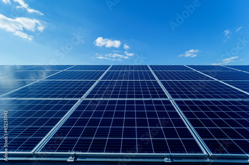 Photovoltaic solar panels on blue sky background photo